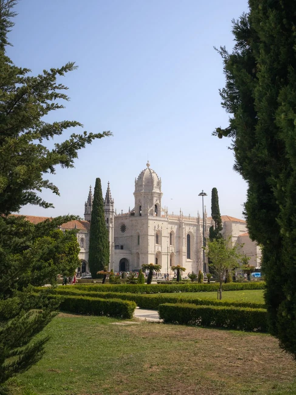 Le monastère des Hiéronymites vu depuis les jardins de la Praça do Império, entre deux cyprès