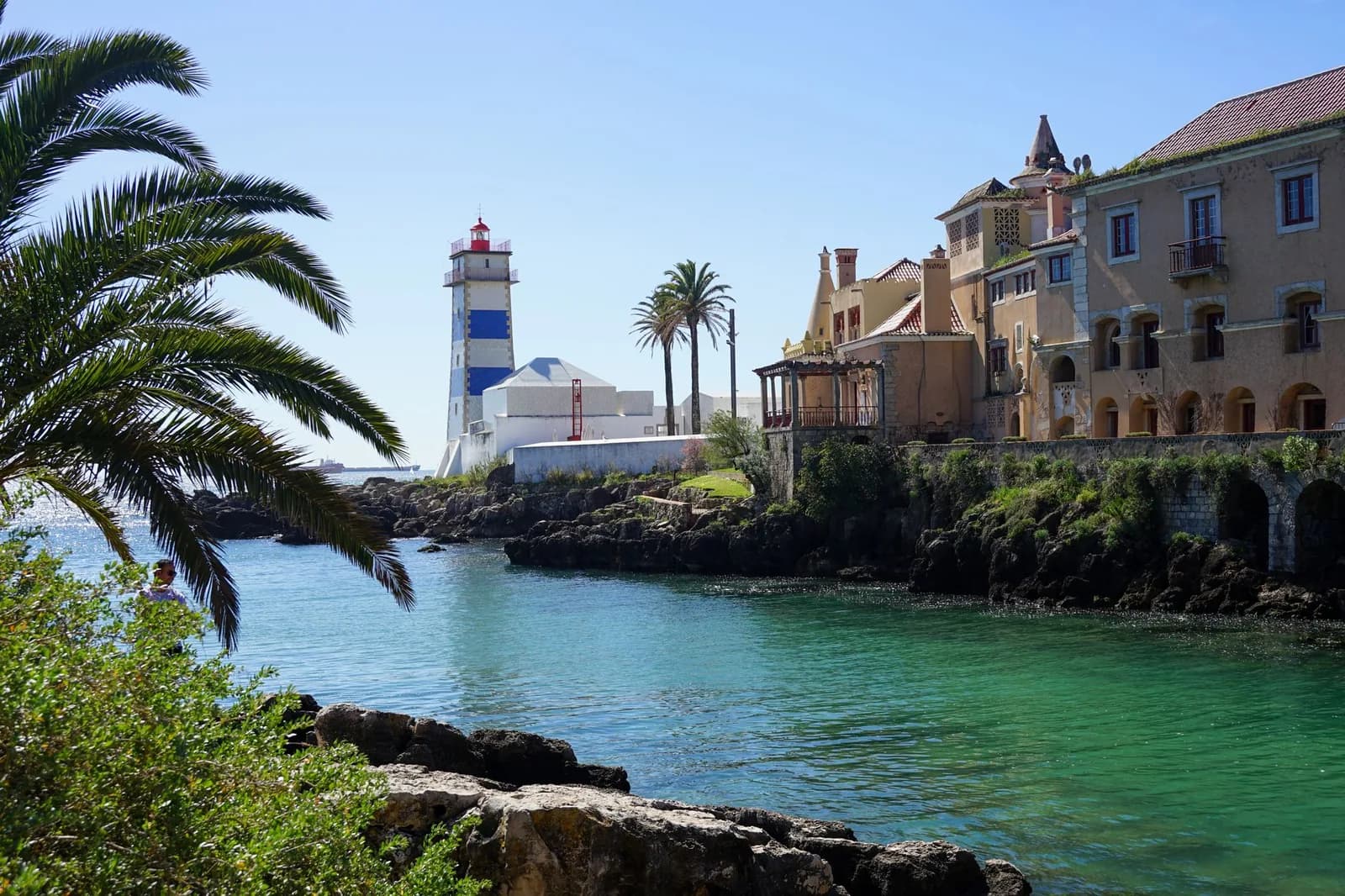 Le phare rayé de Santa Marta derrière les palmiers, au bord de l'eau